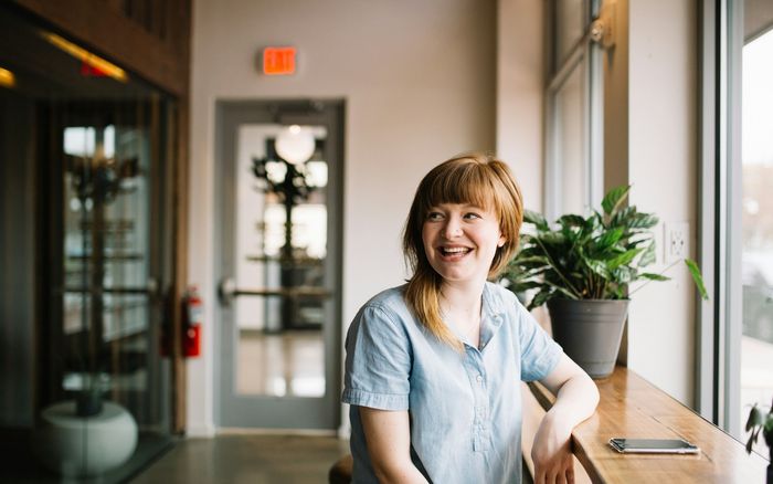A business owner sitting at a wooden table planning