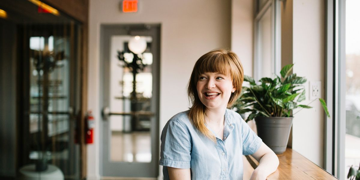 A business owner sitting at a wooden table planning