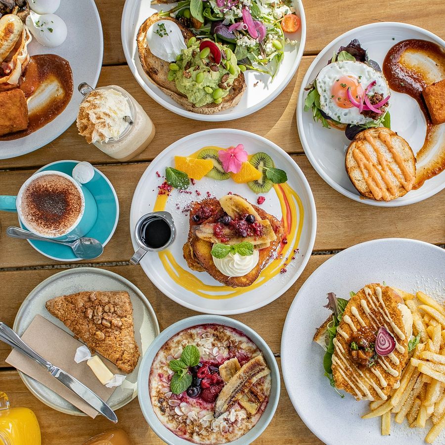 A spread of brunch dishes on a New Zealand cafe table