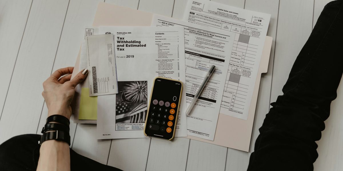 Paperwork, a pen and a calculator on a desk