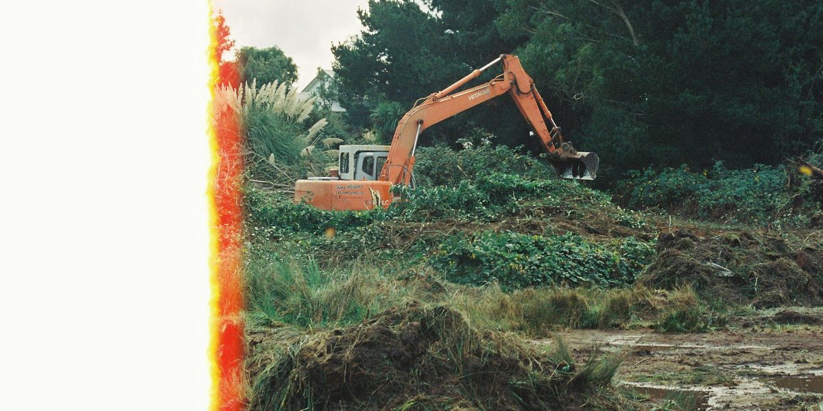 A digger clearing land for site works