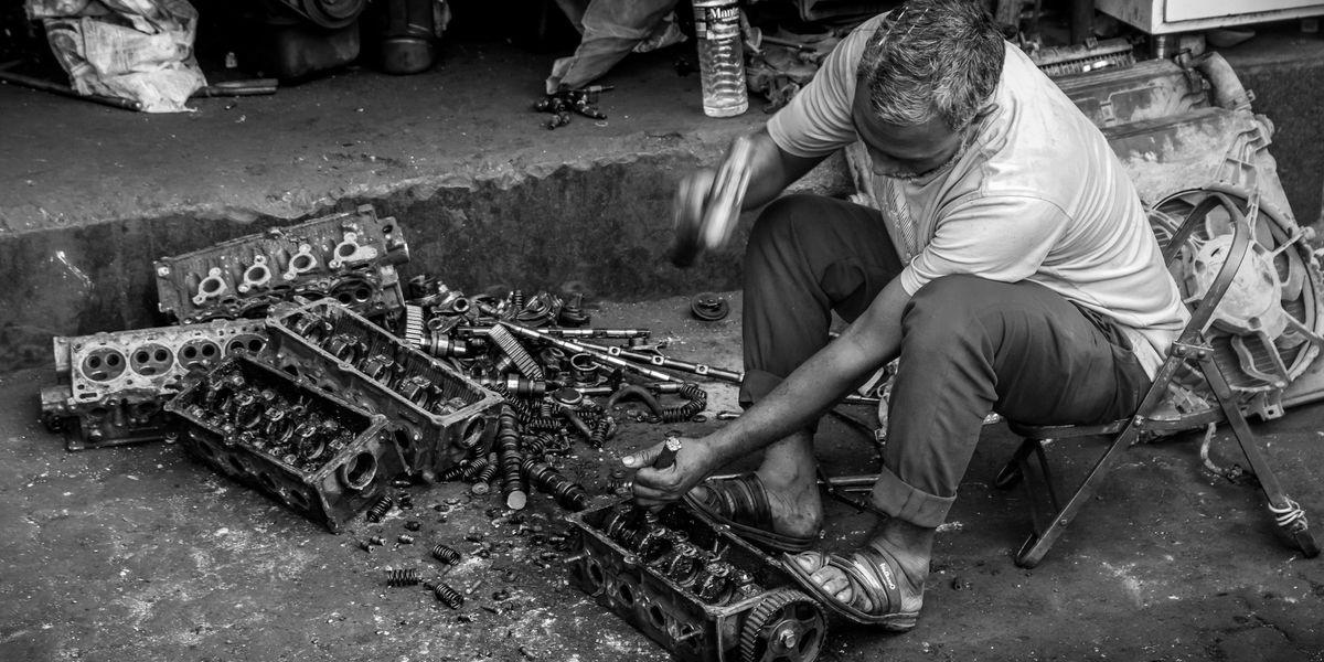 A mechanic working on car engine parts