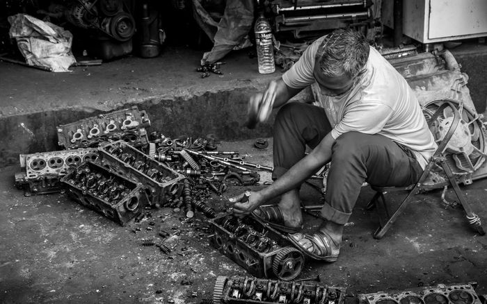 A mechanic working on car engine parts