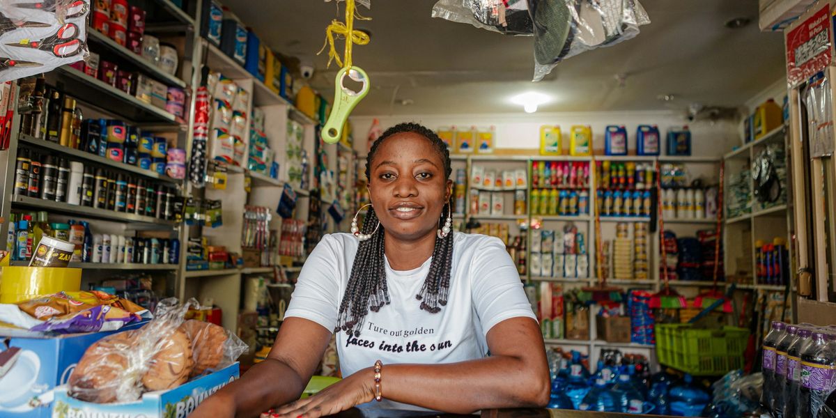 A shop owner sitting at the counter of her store
